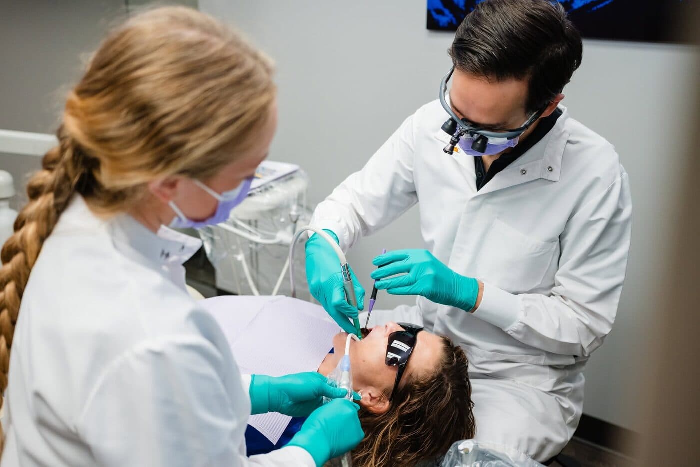 Dr. DePorter and a hygienist caring for a patient